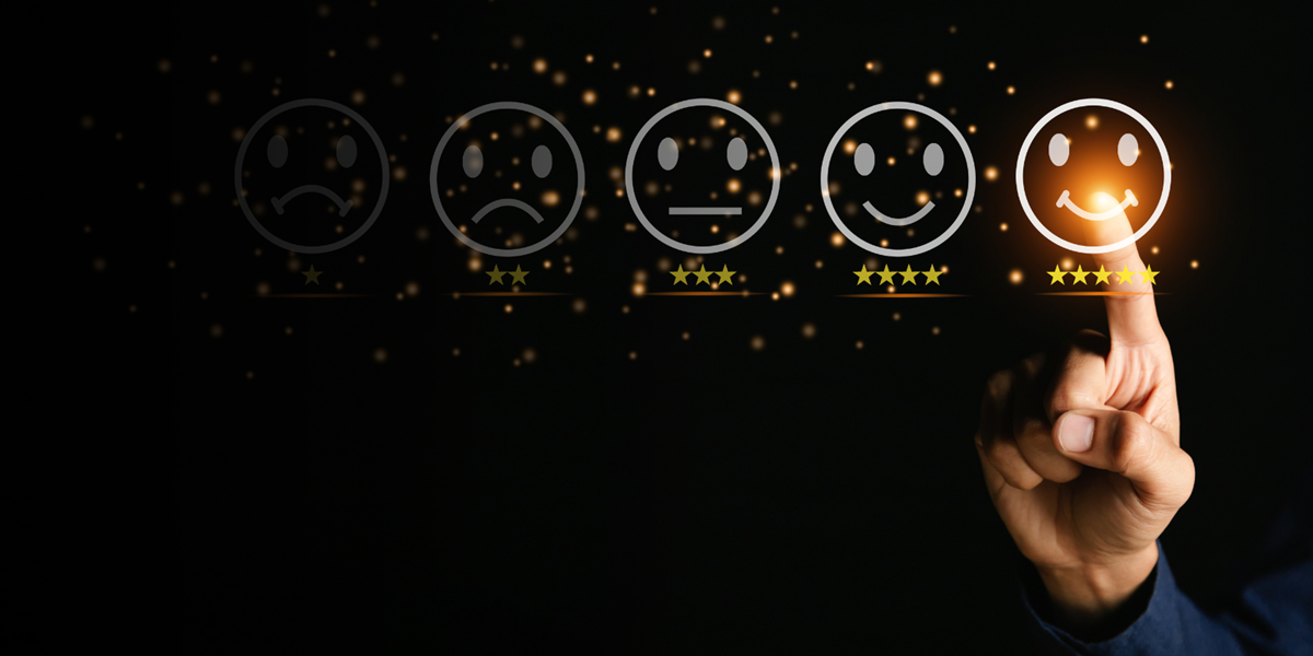 Hand pointing to a smiley face.