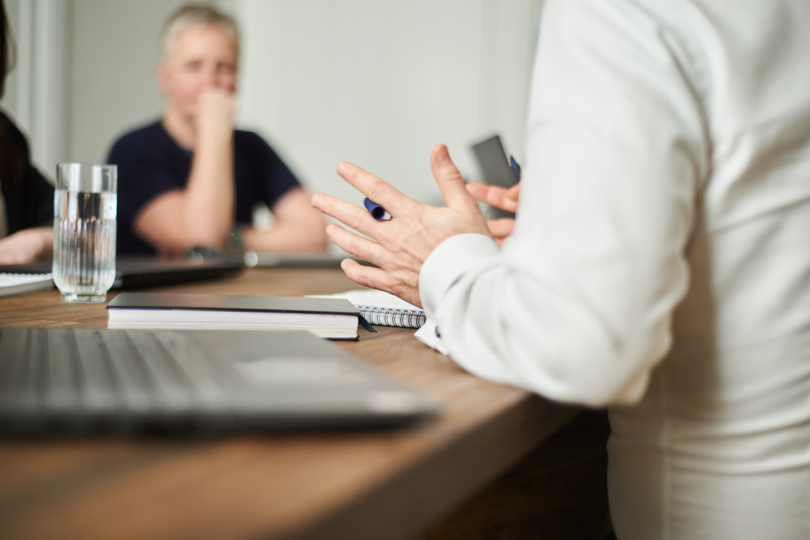 Video and Animation: Picture of hands holding a pen. In the background is a laptop.