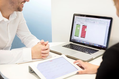 Desk with laptop and notebook.