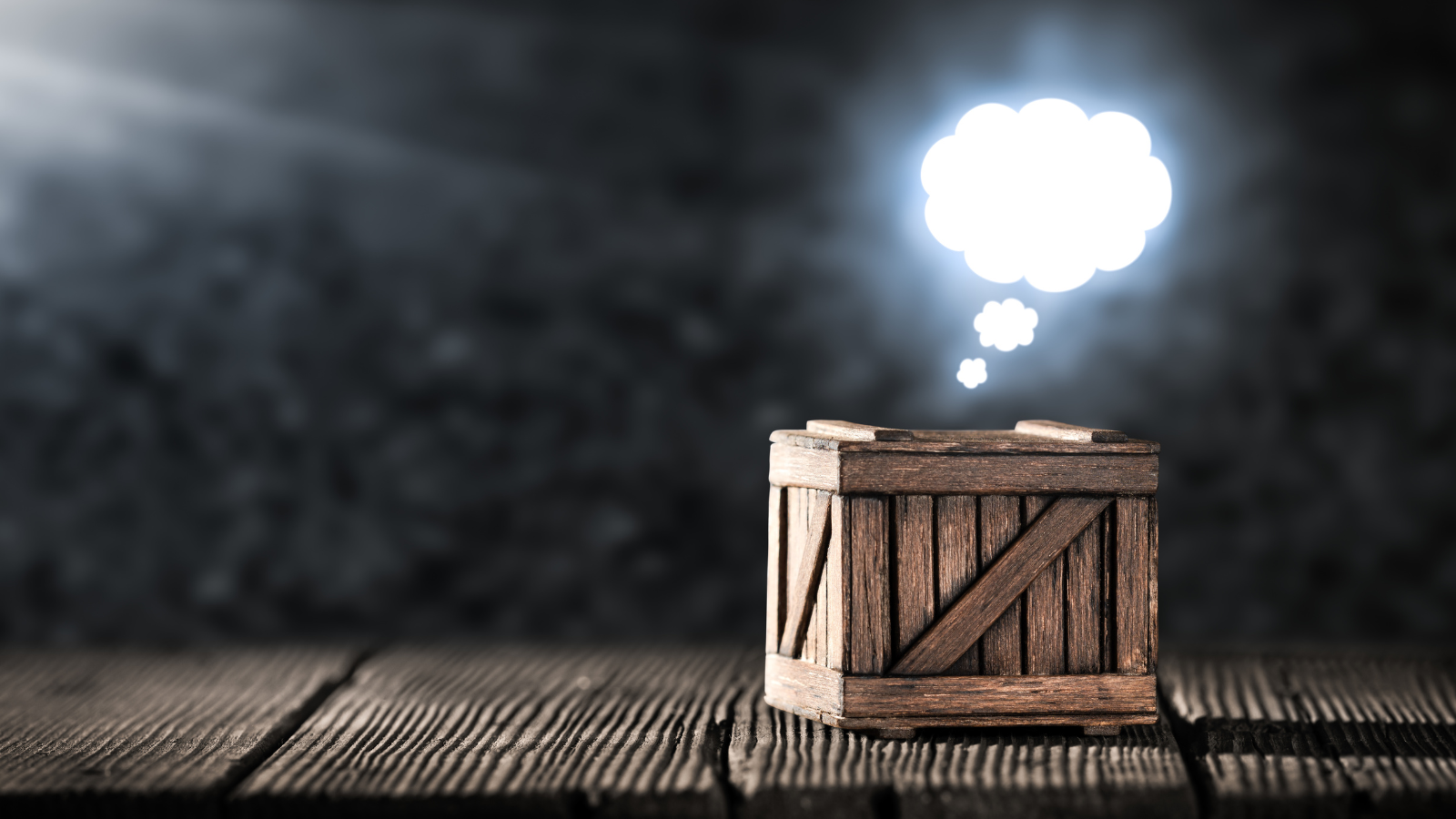 Wooden crate with thought bubble. Thinking outside the box.
