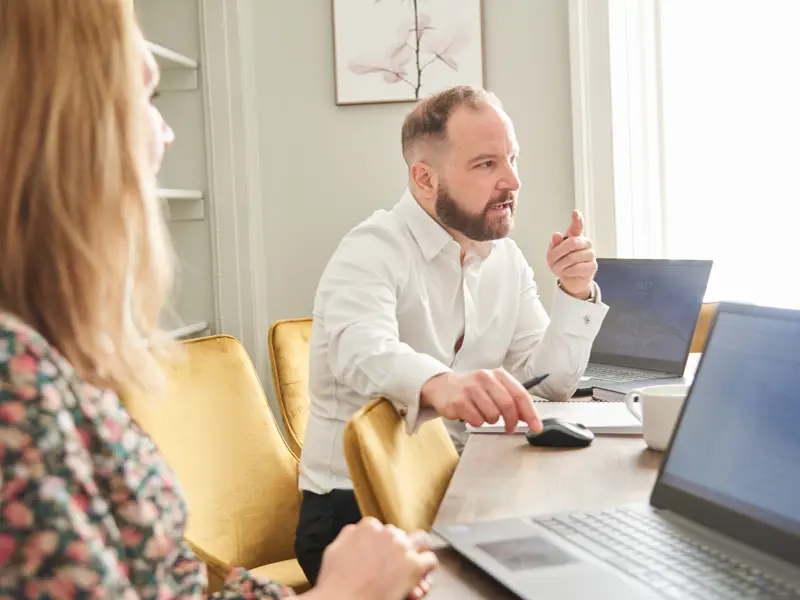 Strategic marketing: Chris Lucarelli sitting at a table in conversation.