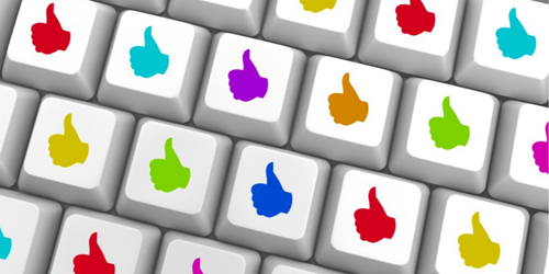 Keyboard keys with thumbs up emoji in multi colours.