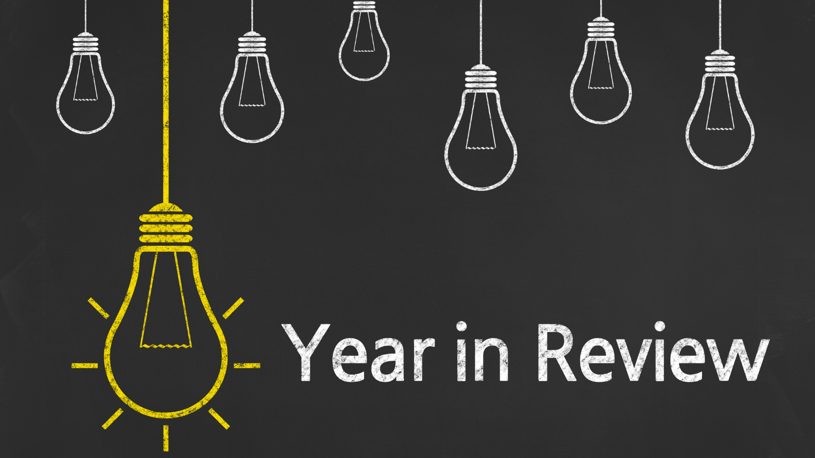 Blackboard with a yellow light bulb drawn on.  Words say ' A Year in Review.'