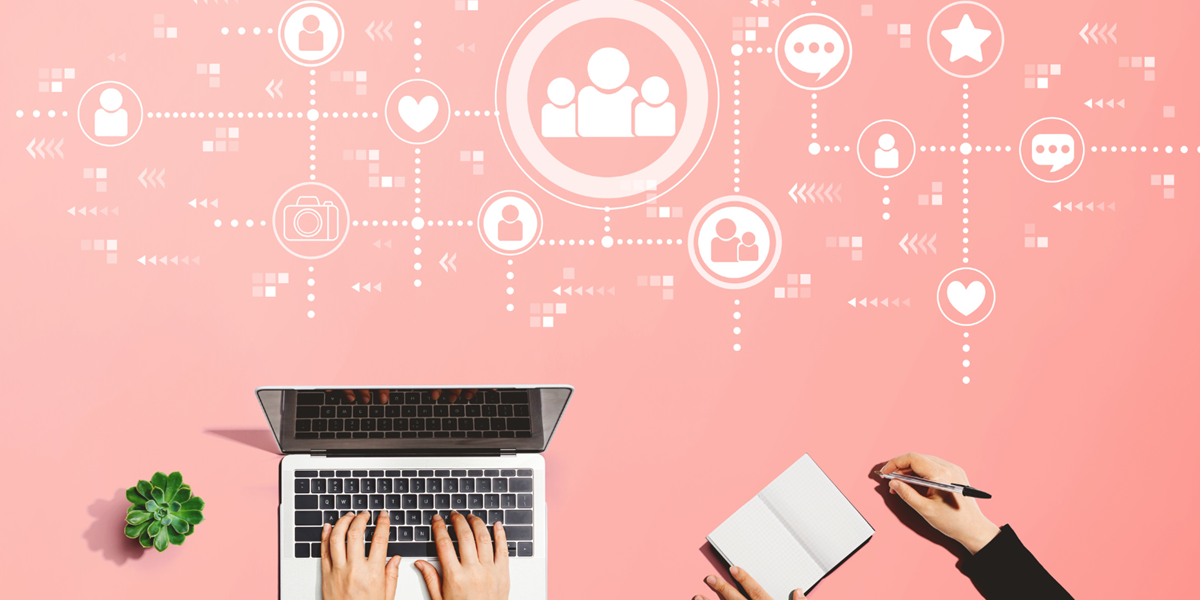 Hand typing on laptop. Above the laptop are thumbnails of people and emojis each connected by dotted lines.