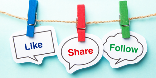 A line and pegs holding signs saying 'like', 'share' and 'follow'.