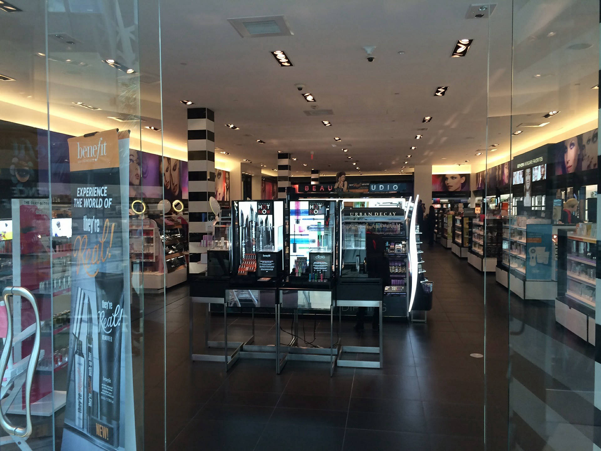 Looking inside a cosmetics store at the display showing multiple choices of beauty products.